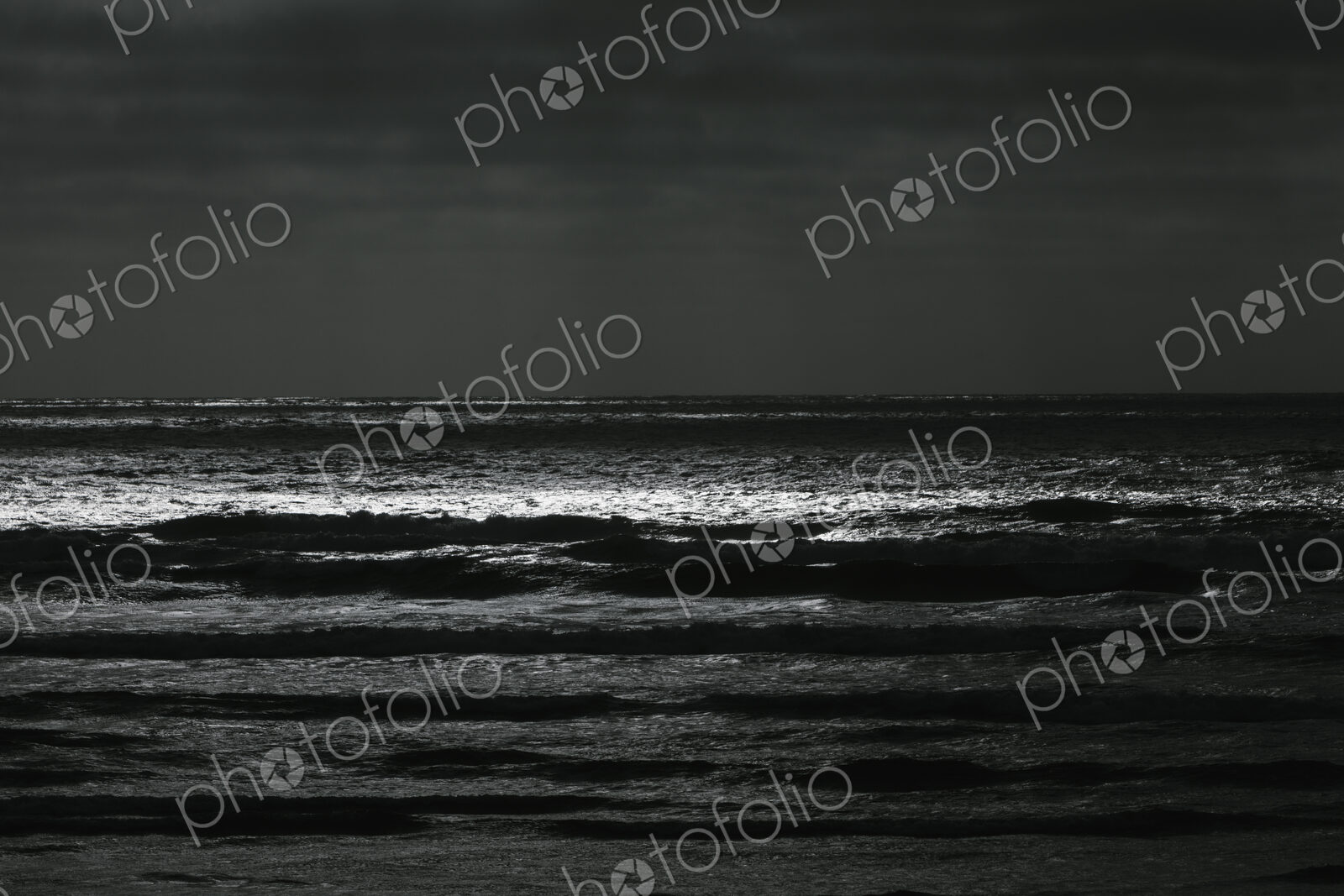 Breaking waves and moody sky at dusk