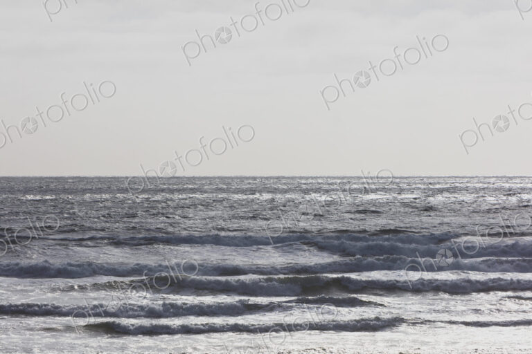 Breaking waves and moody sky at dusk