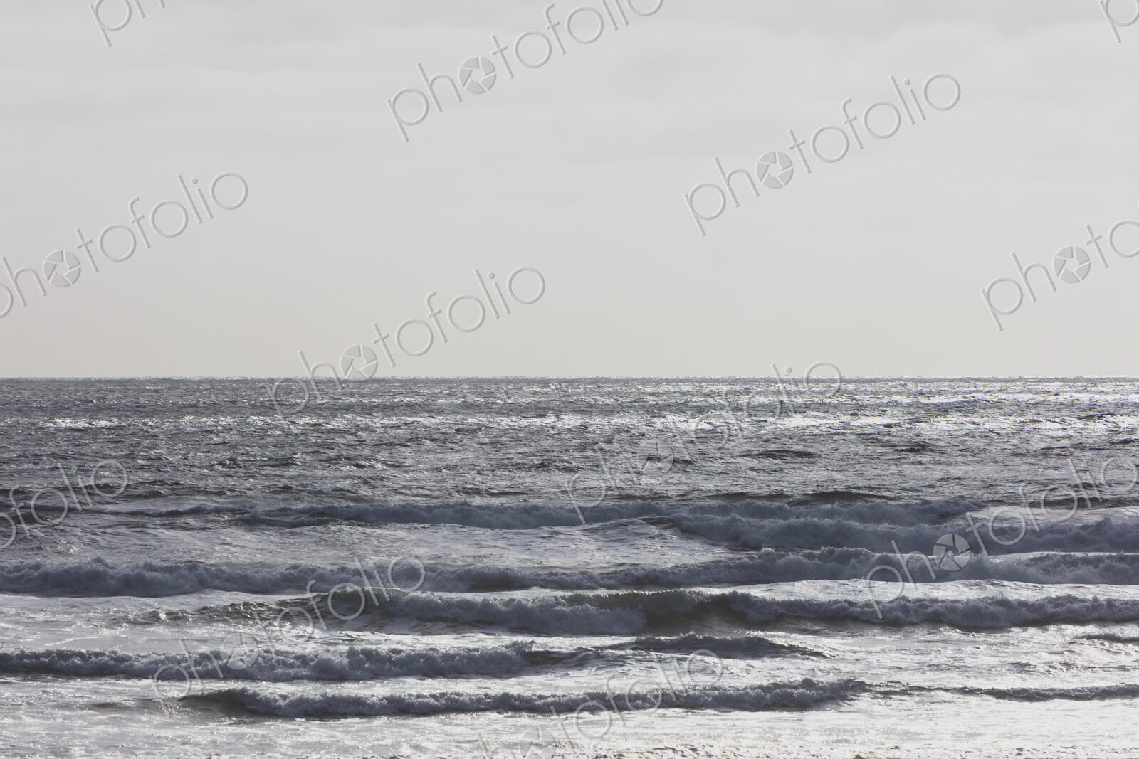 Breaking waves and moody sky at dusk