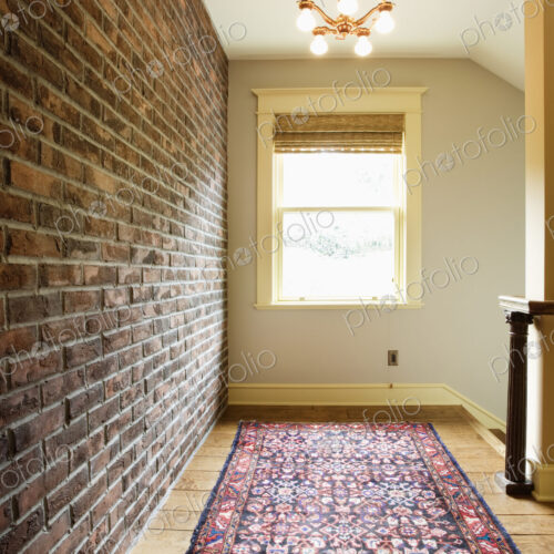 Brick wall along corridor in house Brick wall along corridor in house
