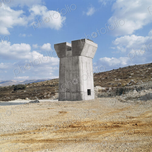 Bridge under construction, pillars and elevated road across an arid landscape. Bridge under construction, pillars and elevated road across an arid landscape.