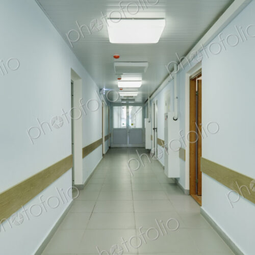 Brightly lit corridor in a sports hall with doors leading off it. Brightly lit corridor in a sports hall with doors leading off it.