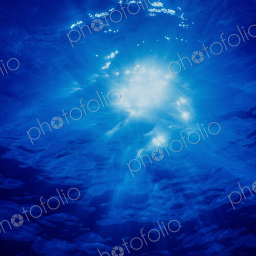 Brilliant Crepuscular rays and a sunburst shining through moving water, view from…