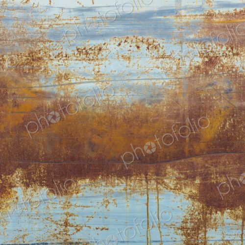 Brown rusting patches on an old wall