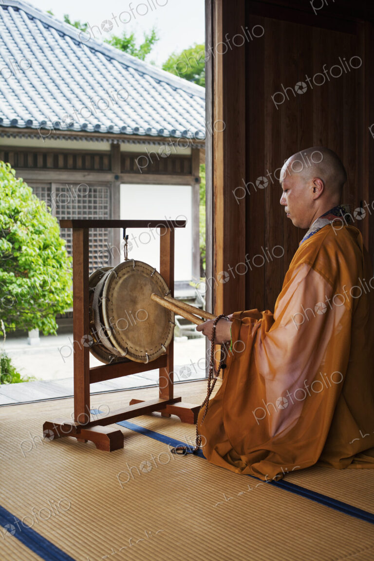 Buddhist monk in a golden robe worshipping