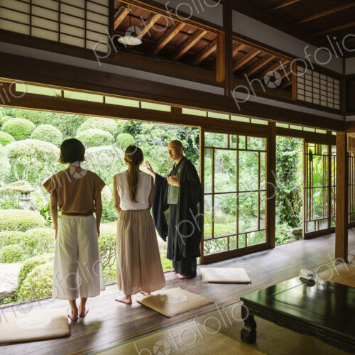 Buddhist priest and two Japanese women standing in Buddhist temple. Buddhist priest and two Japanese women standing in Buddhist temple.