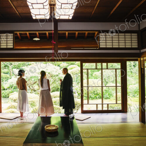 Buddhist priest and two Japanese women standing in Buddhist temple. Buddhist priest and two Japanese women standing in Buddhist temple.