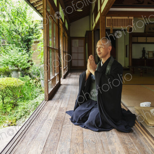Buddhist priest kneeling in Buddhist temple, praying. Buddhist priest kneeling in Buddhist temple, praying.