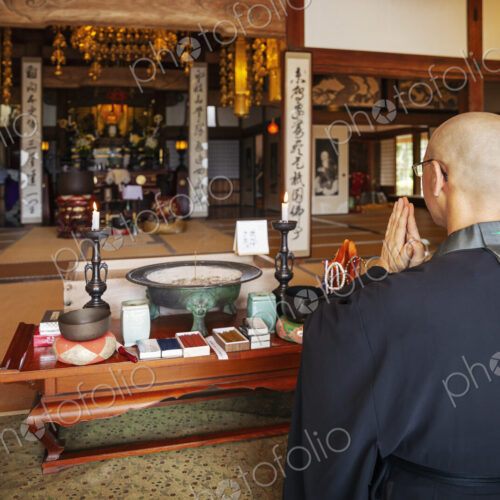 Buddhist priest kneeling in Buddhist temple, praying. Buddhist priest kneeling in Buddhist temple, praying.