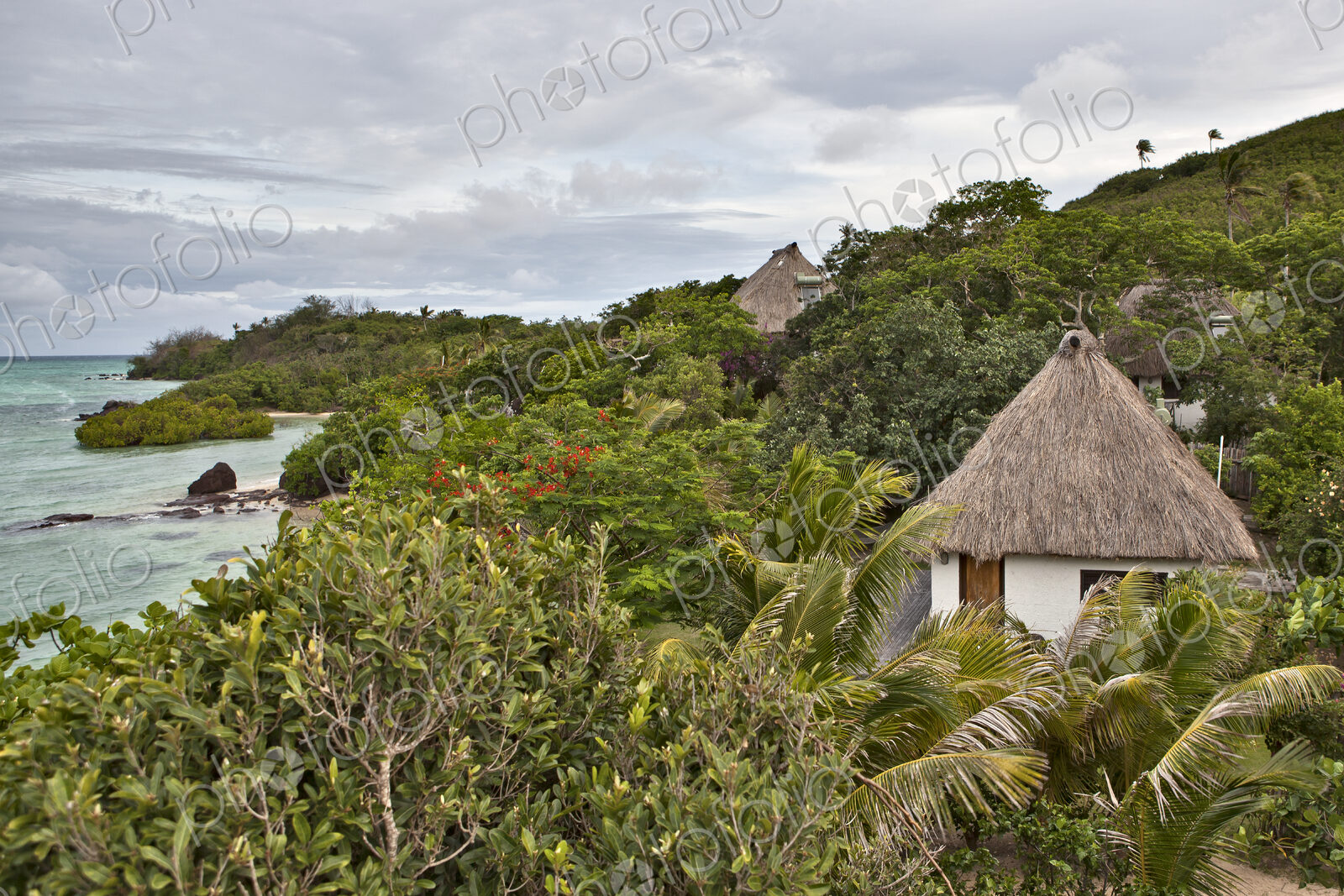 Buildings With Thatched Roofs On Tropical Island