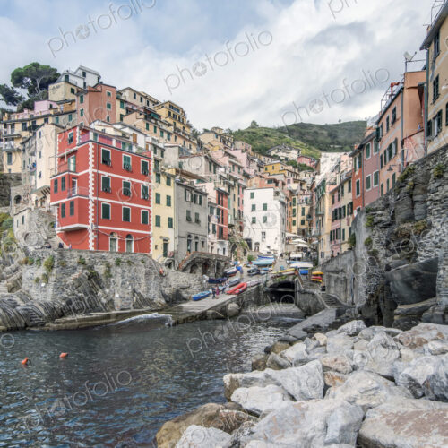 Buildings and rocky coastline near harbor, Manarola, La Spezia, Italy