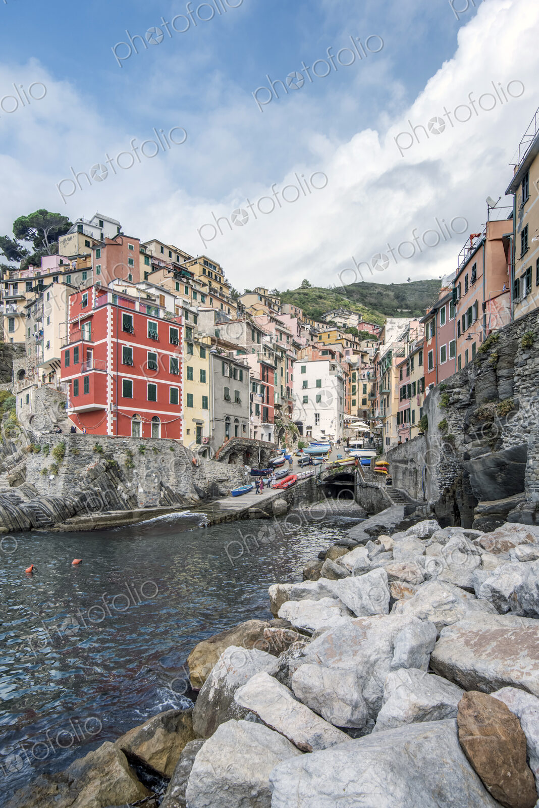Buildings and rocky coastline near harbor, Manarola, La Spezia, Italy