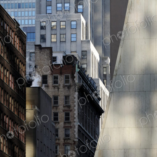 Buildings in New York City, view from below, historic and modern architecture, shadows…
