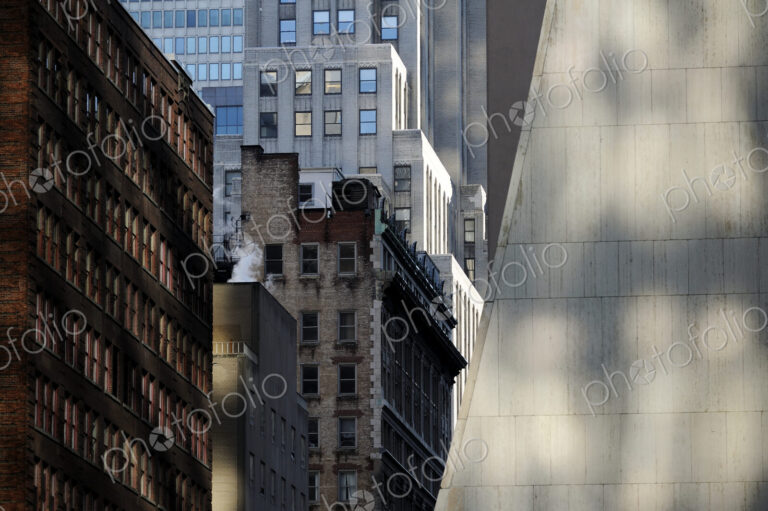 Buildings in New York City, view from below, historic and modern architecture, shadows…