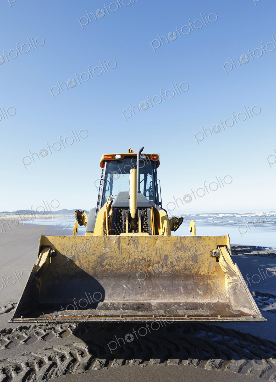 Bulldozer on a sandy beach.