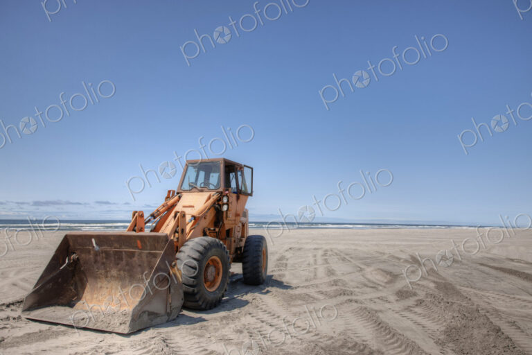 Bulldozer on sandy beach.