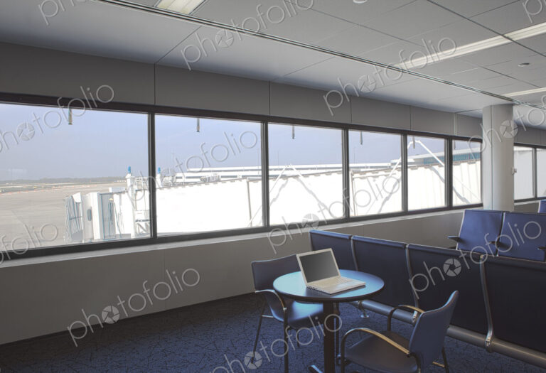Business airport lounge, view outside and a laptop on a table