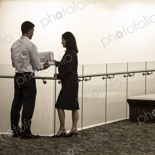 Business people in a conference center hallway.