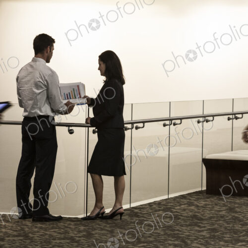 Business people in a conference center hallway.