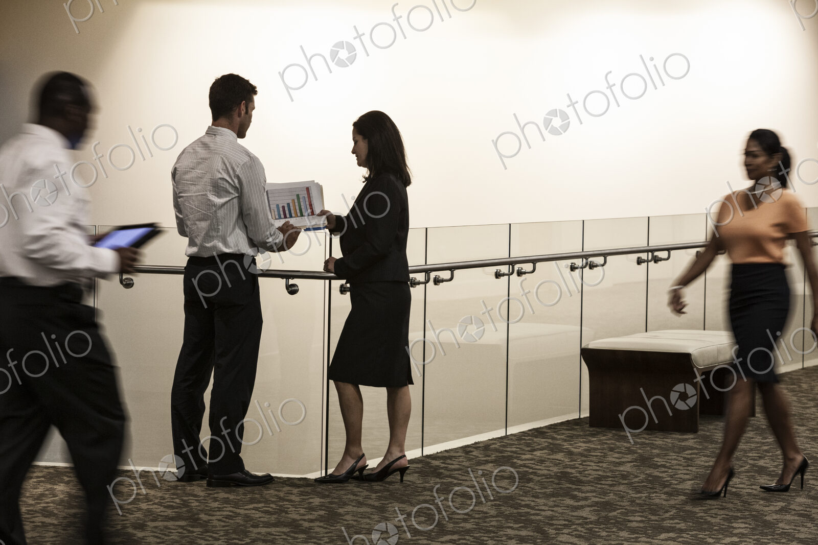 Business people in a conference center hallway.