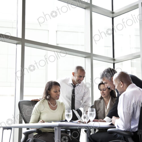 Business people in a meeting at a conference table Business people in a meeting at a conference table