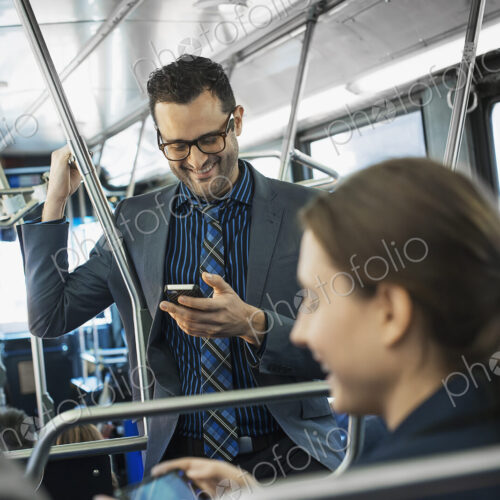 Business people in the city. Three people on the move, two men and a woman, on the bus. Business people in the city. Three people on the move, two men and a woman, on the bus.