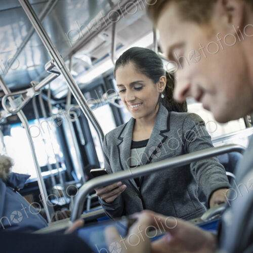Business people in the city. Three people on the move, two men and a woman, on the bus. Business people in the city. Three people on the move, two men and a woman, on the bus.