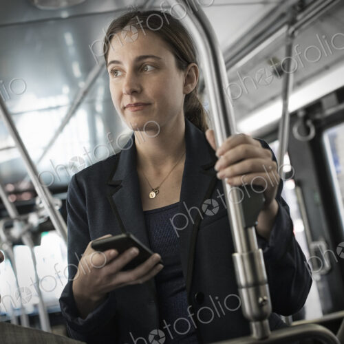 Business people in the city. Two people, a man and woman on a bus. Business people in the city. Two people, a man and woman on a bus.