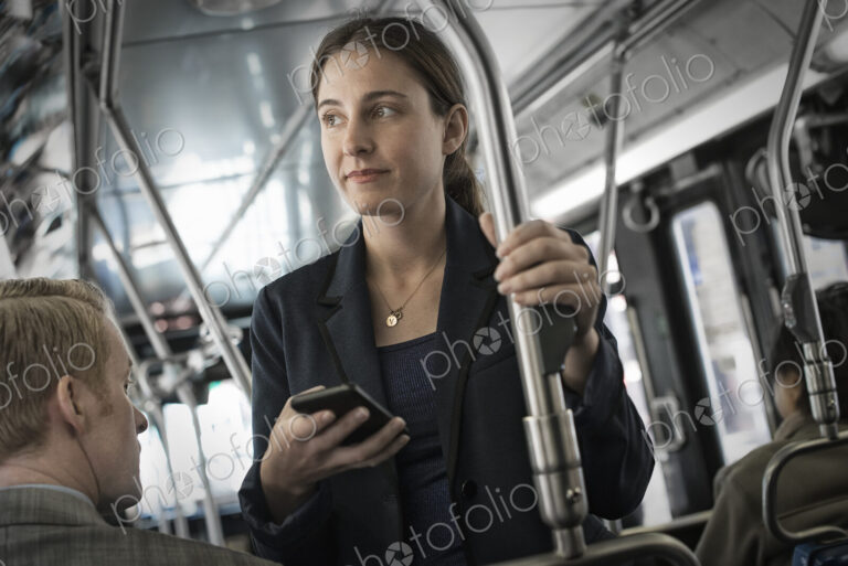 Business people in the city. Two people, a man and woman on a bus.