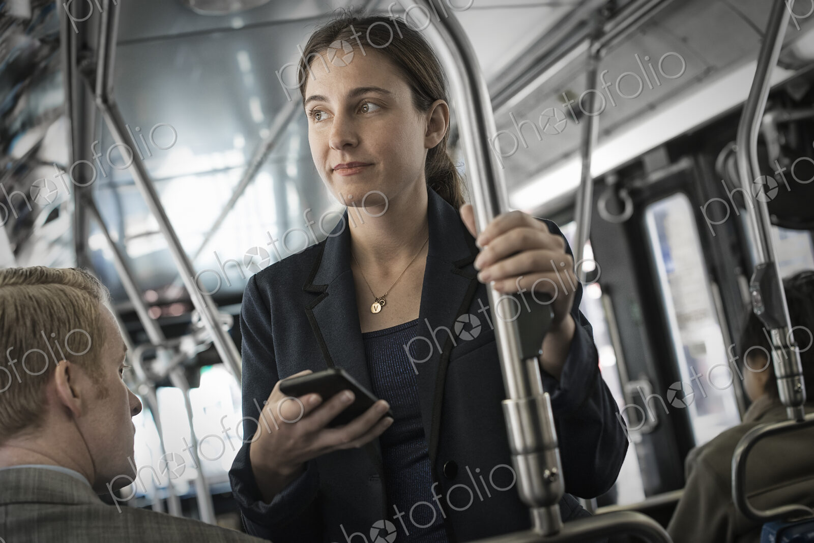 Business people in the city. Two people, a man and woman on a bus.