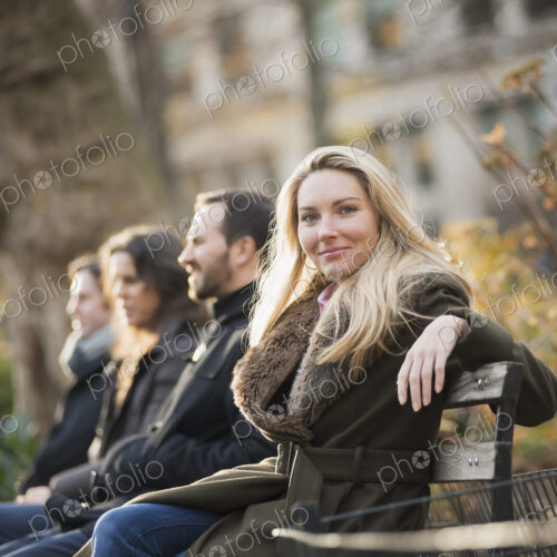 Business people on bench in urban park Business people on bench in urban park