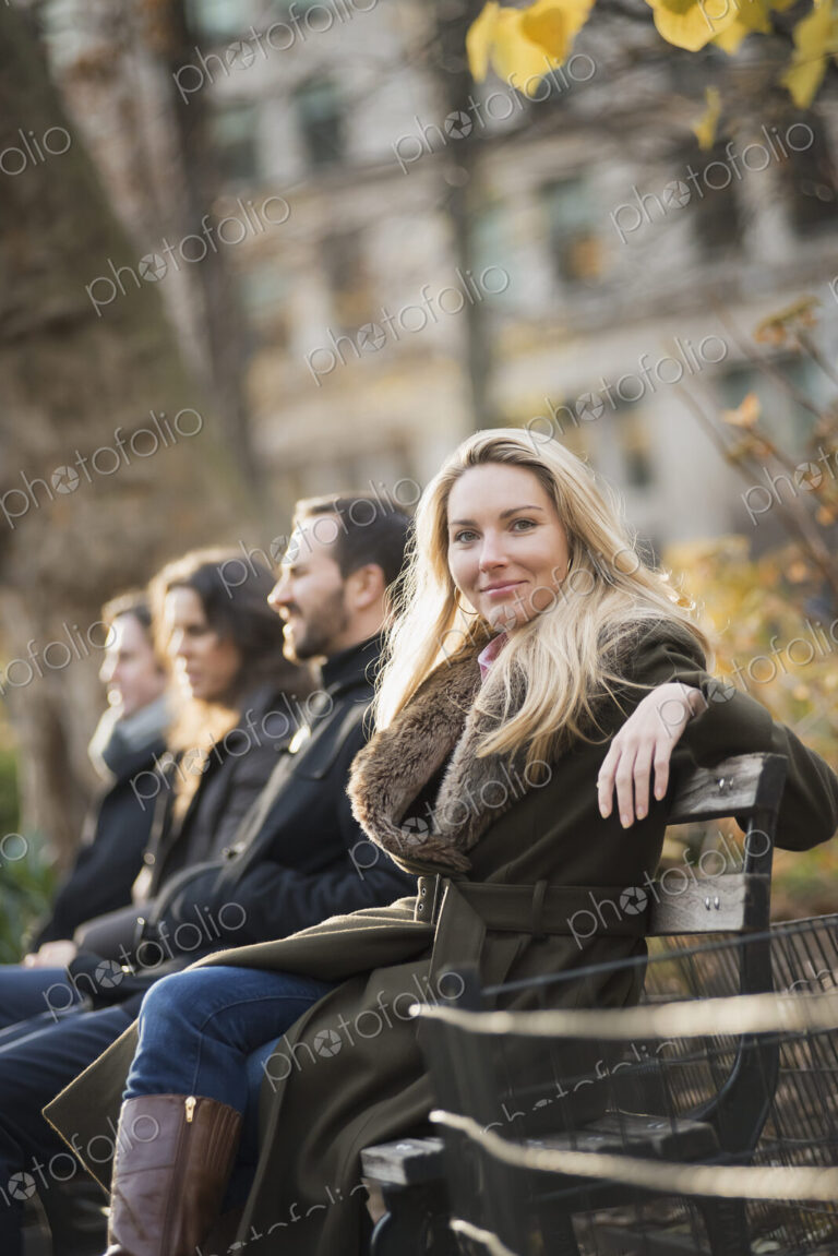 Business people on bench in urban park