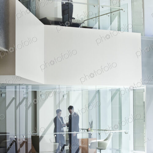 Business people on two floors of a large business center. Business people on two floors of a large business center.