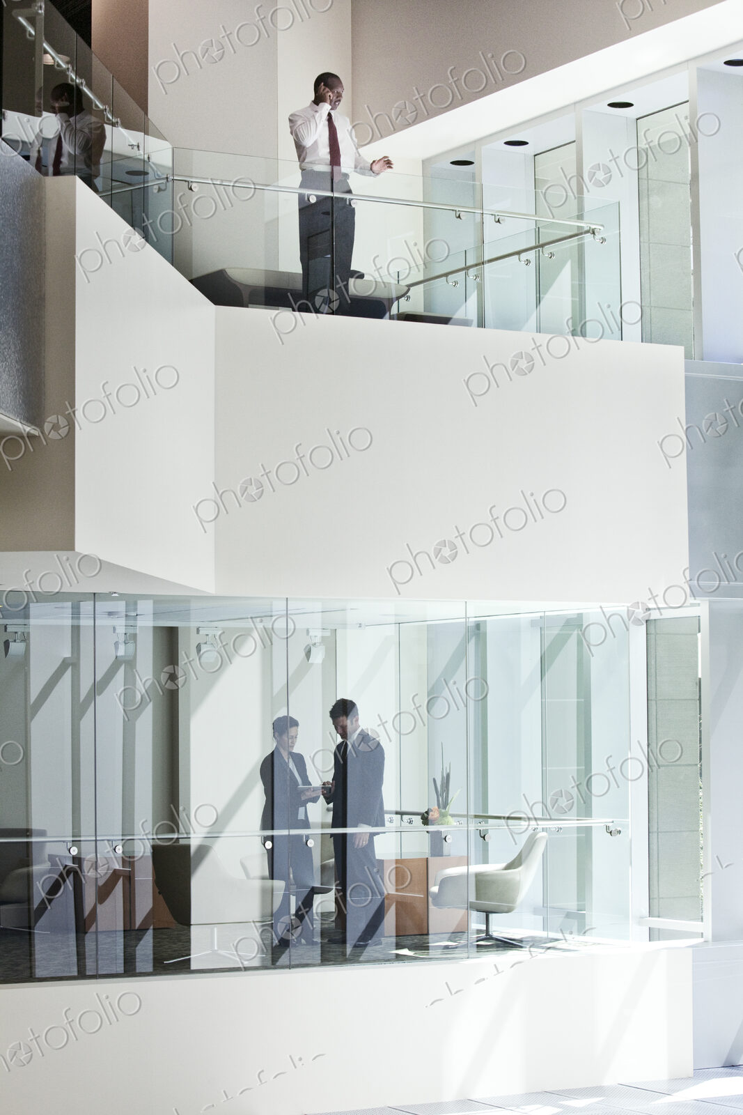 Business people on two floors of a large business center.