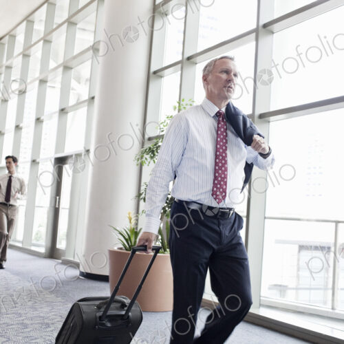 Business people walking through a covered walkway on the way to catch a plane. Business people walking through a covered walkway on the way to catch a plane.