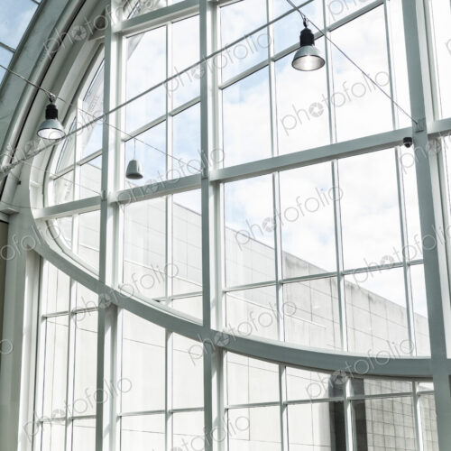 Businessman and woman meeting in a large glass covered walkway