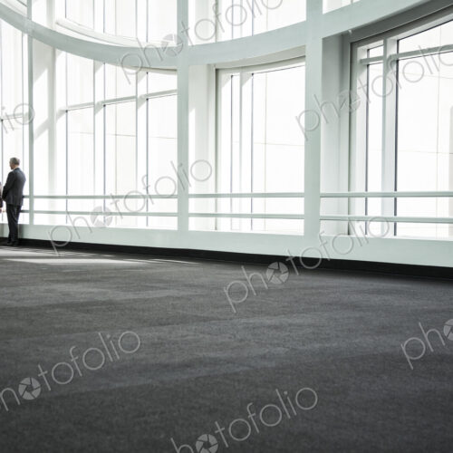 Businessman and woman meeting in a large glass covered walkway Businessman and woman meeting in a large glass covered walkway