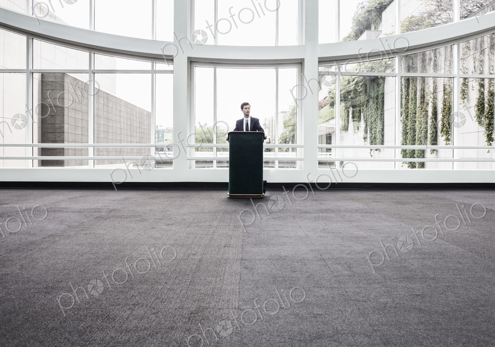Businessman at a podium with no one to talk to.