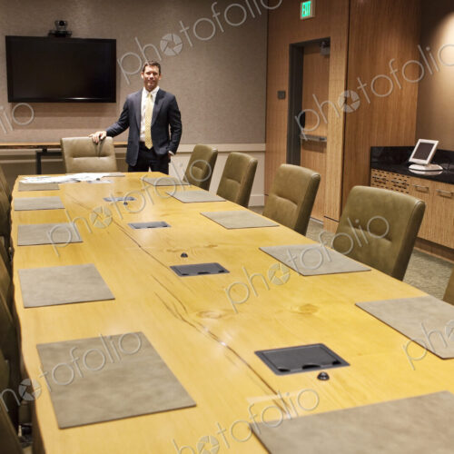 Businessman at the head of a large conference room table. Businessman at the head of a large conference room table.
