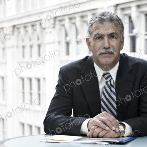Businessman sitting at a desk with a city view