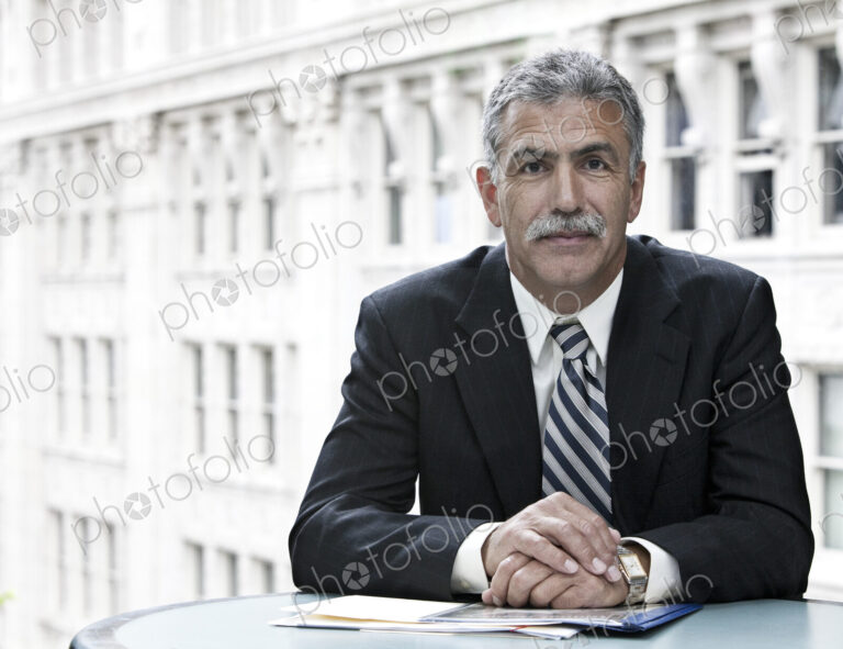 Businessman sitting at a desk with a city view