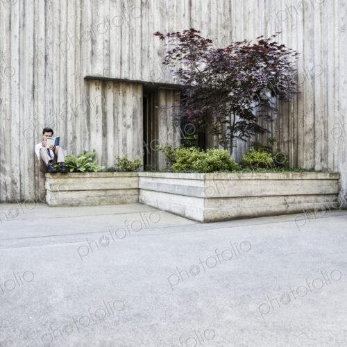 Businessman taking a break in a city park alcove. Businessman taking a break in a city park alcove.