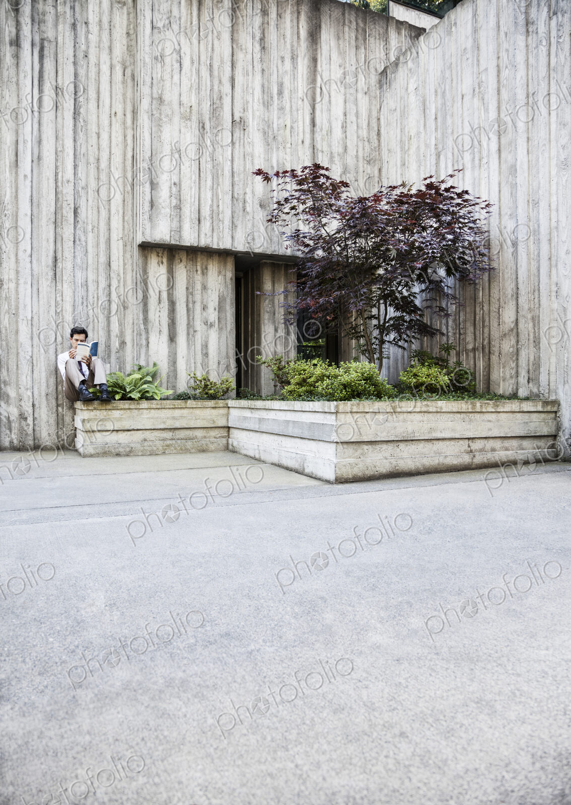 Businessman taking a break in a city park alcove.