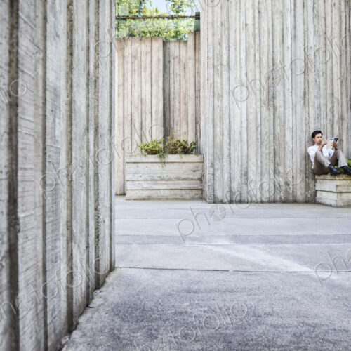 Businessman taking a break in a city park alcove. Businessman taking a break in a city park alcove.