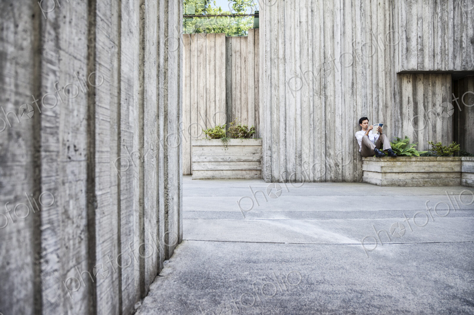 Businessman taking a break in a city park alcove.
