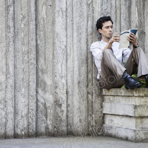 Businessman taking a break in a city park alcove. Businessman taking a break in a city park alcove.