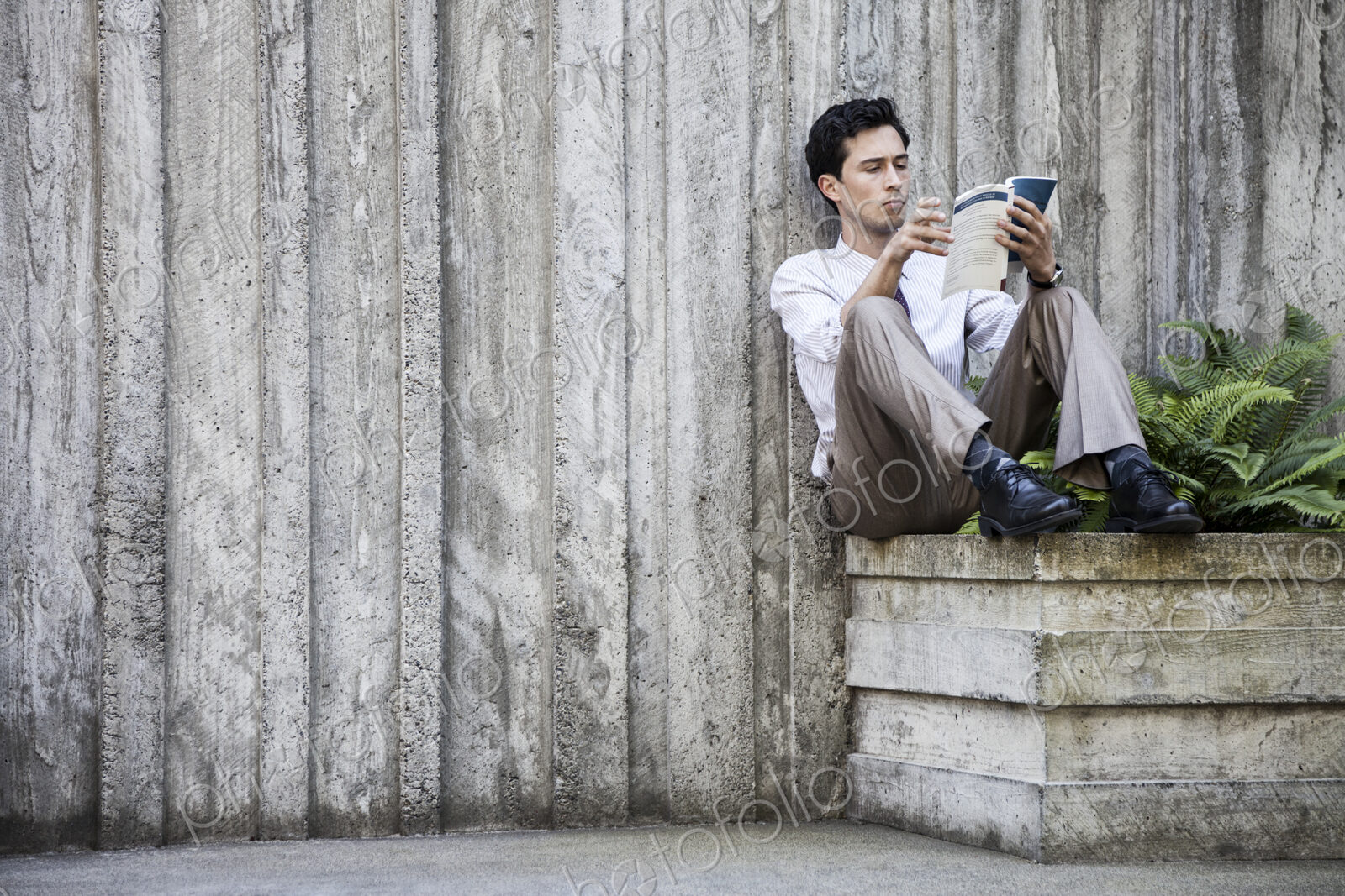 Businessman taking a break in a city park alcove.