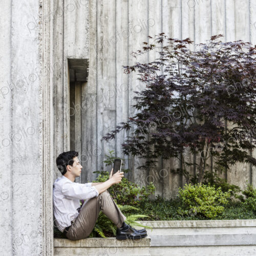 Businessman taking a break in a city park alcove. Businessman taking a break in a city park alcove.