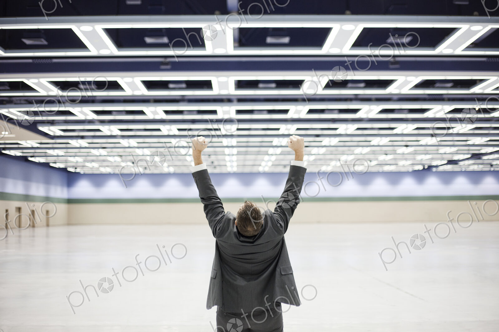 Businessman with his arms stetched in the air in open space celebrating
