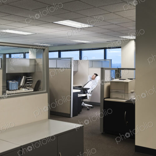 Businessman working in cubicle office. Businessman working in cubicle office.